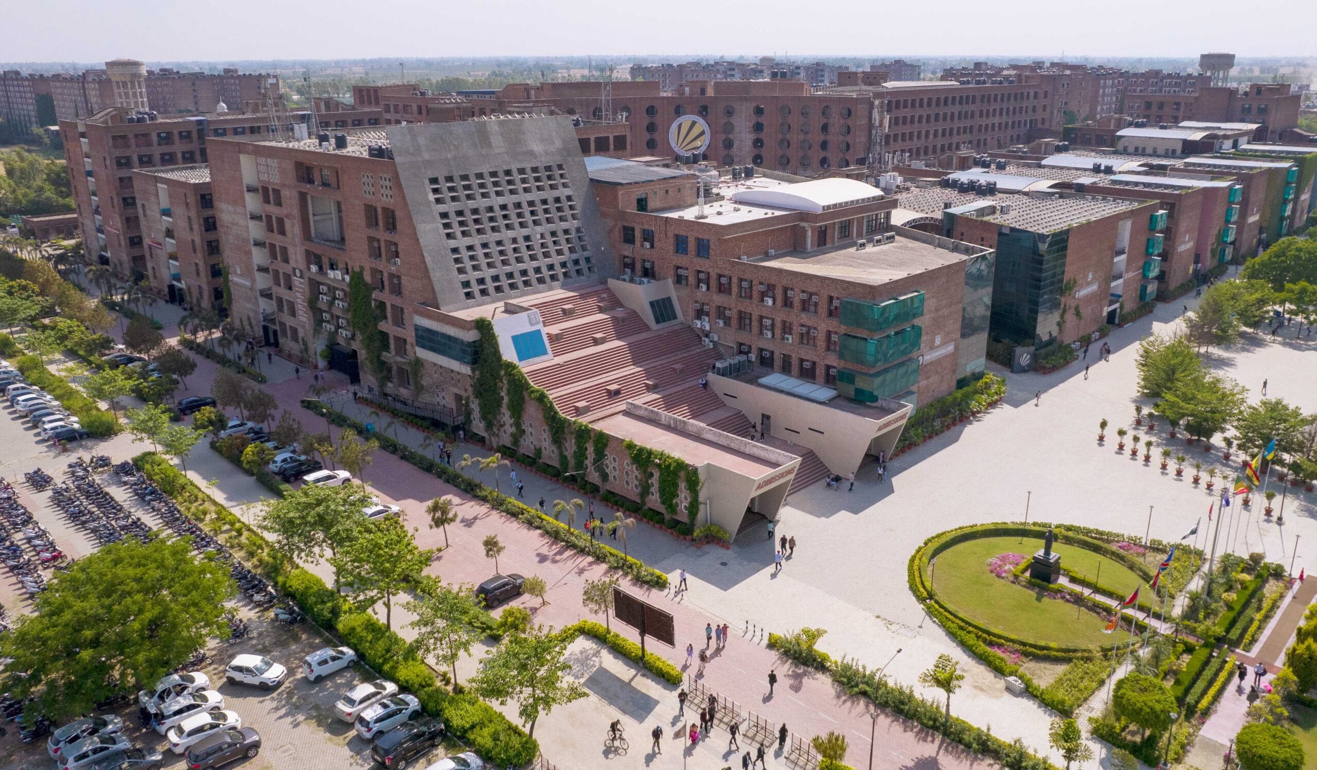 Aerial photograph of Lovely Professional University's campus, showing its brick buildings, central plaza and landscaped areas